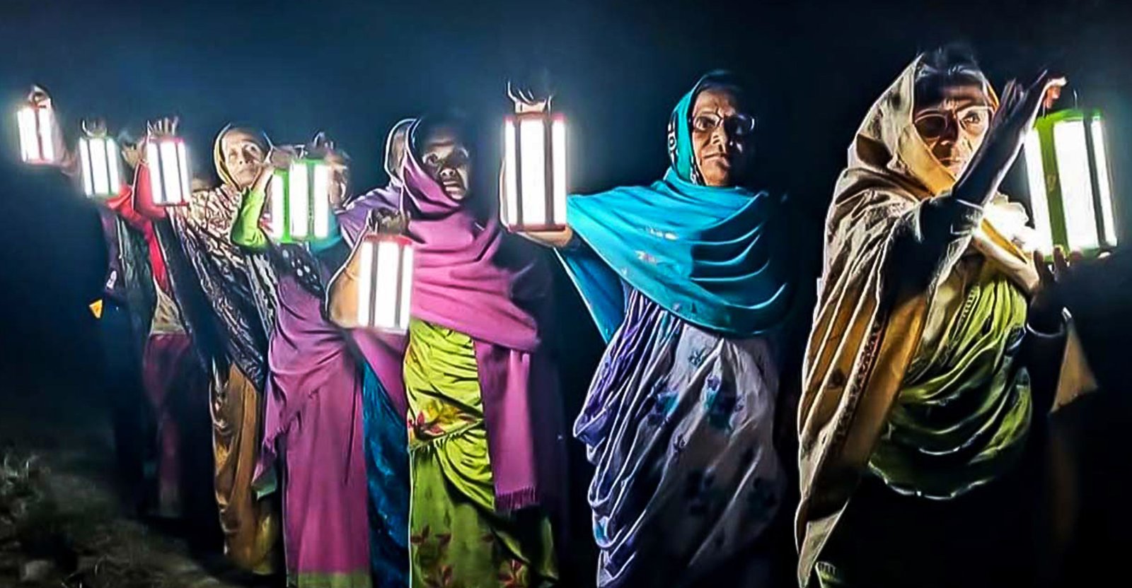 A woman with a scrunched smile gives a side hug to her mother.